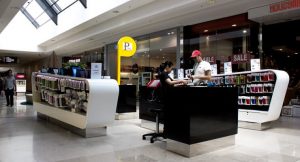 Two people talking at black and white kiosk