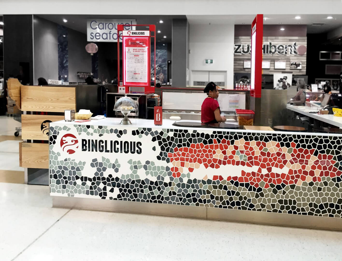 Employee inside the Binglicious kiosk