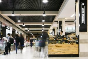 People shopping around wood frog bakery