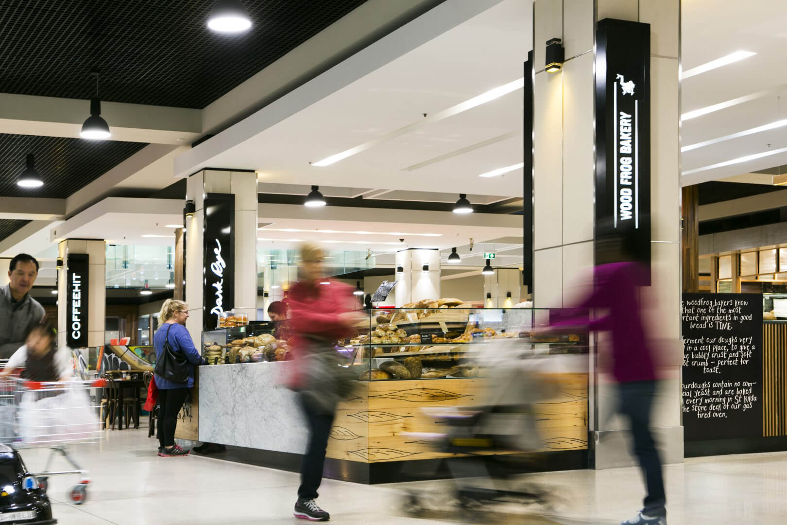 Customer with trolley near wood frog bakery