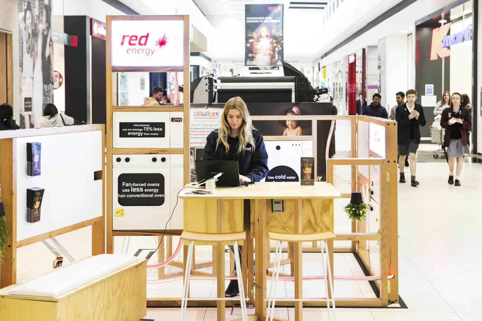 Lady working on a laptop in Red Energy kiosk