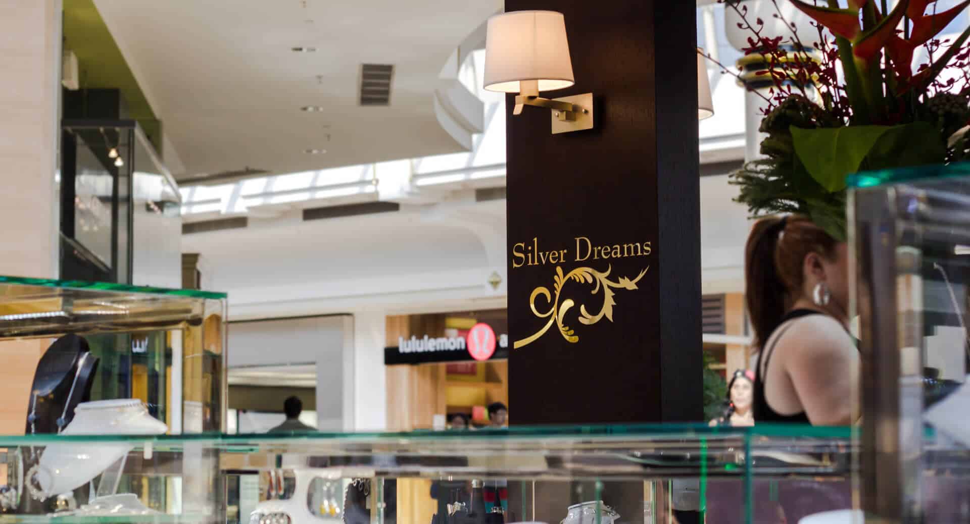 Woman in silver dreams kiosk