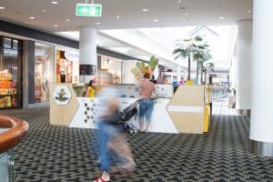 Woman with a pram at a kiosk