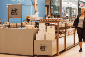Woman walking past Maggie Beer store